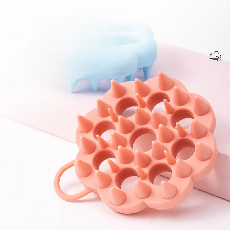 Silicone pet grooming brush with ergonomic handle shown in blue, for use on dog or cat coat during dry grooming or bath.