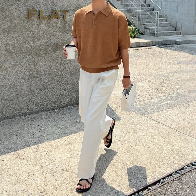 Man modelling a caramel-coloured retro asymmetric knitted polo shirt with short sleeves.