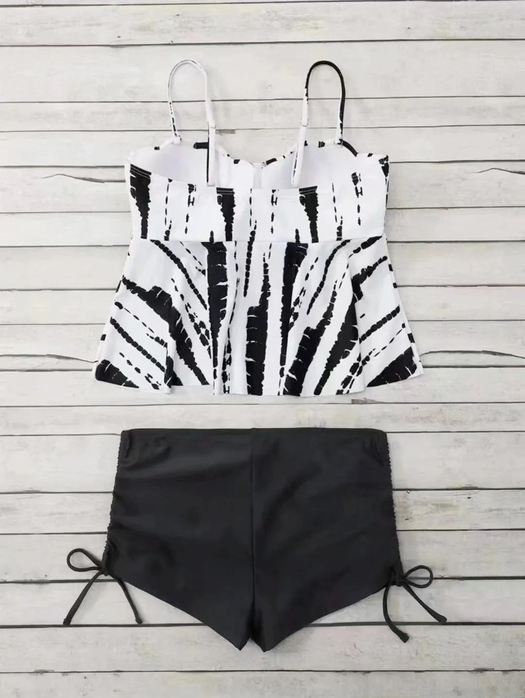 Women's blue printed bikini swimsuit top and shorts set on a mannequin.