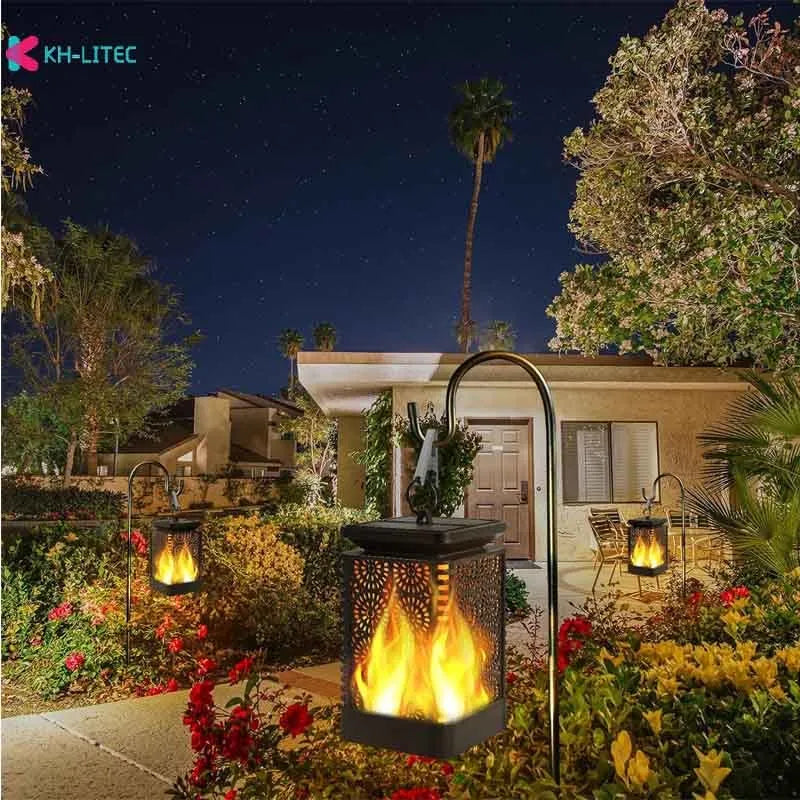 Set of four black solar-powered garden lanterns with flickering LED flame effect.