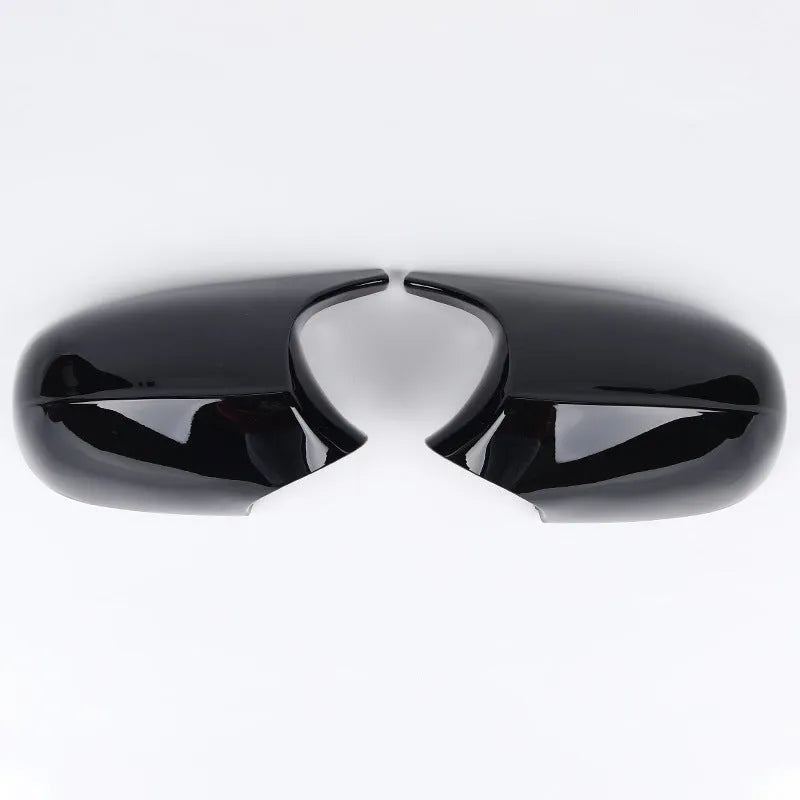 A pair of black ABS plastic rearview mirror shells for a BMW 3 Series E90 car.