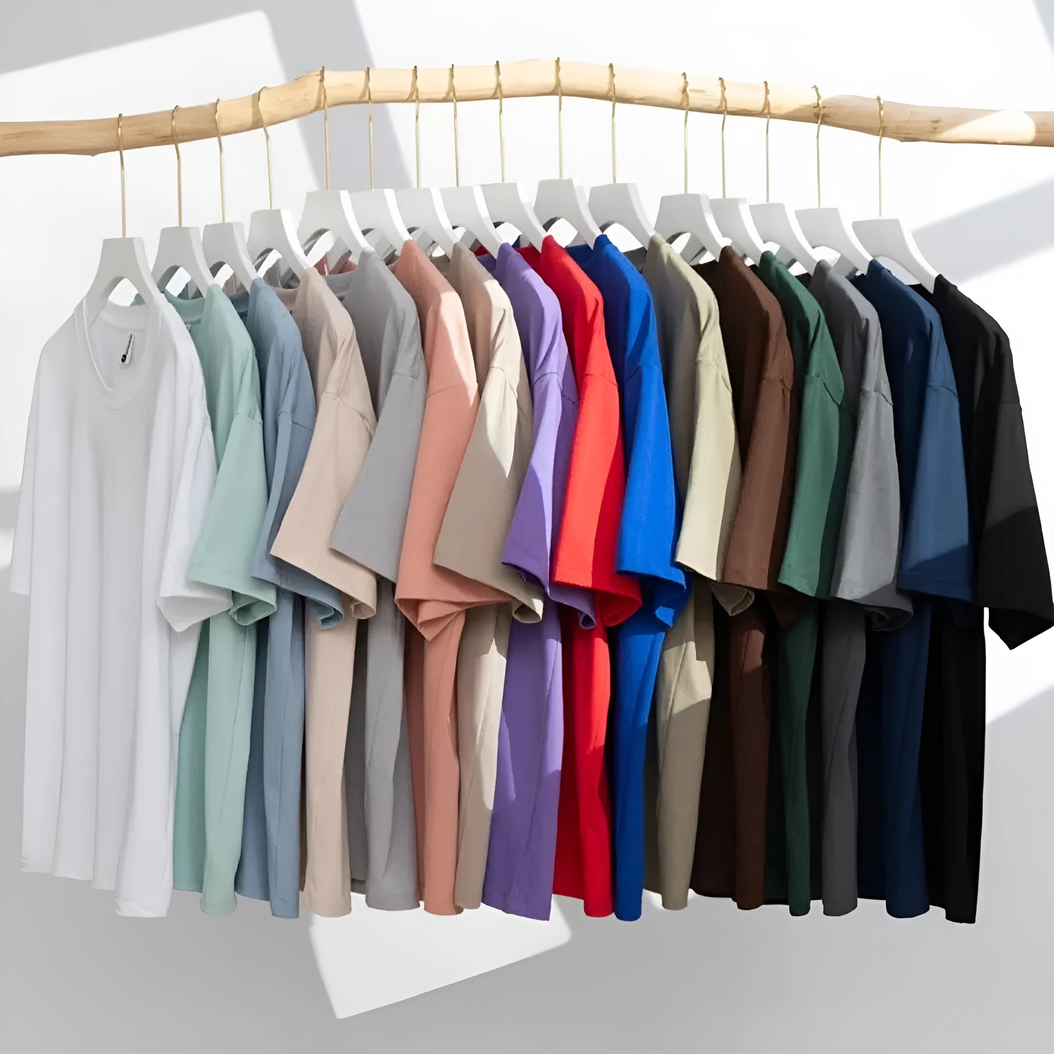 A man and woman modelling a loose-fit, solid colour pure cotton short sleeve T-shirt.