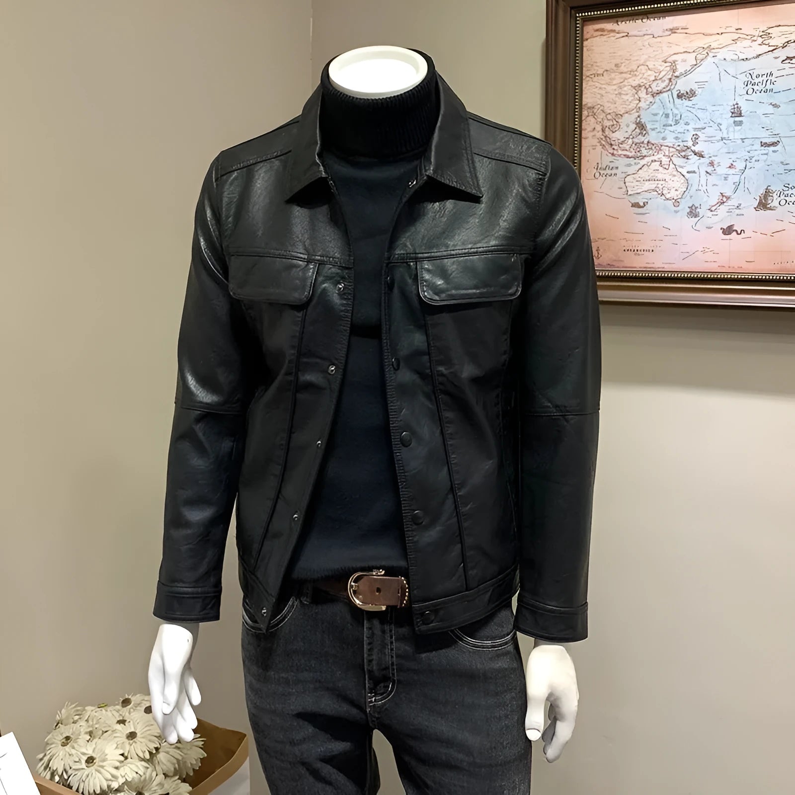 Front view of a black men's artificial leather biker jacket with loose fit, medium length, on a neutral background