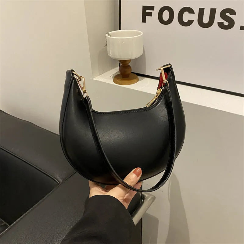 Round green one-shoulder underarm bag with visible sewing lines and sandwich-style compartments