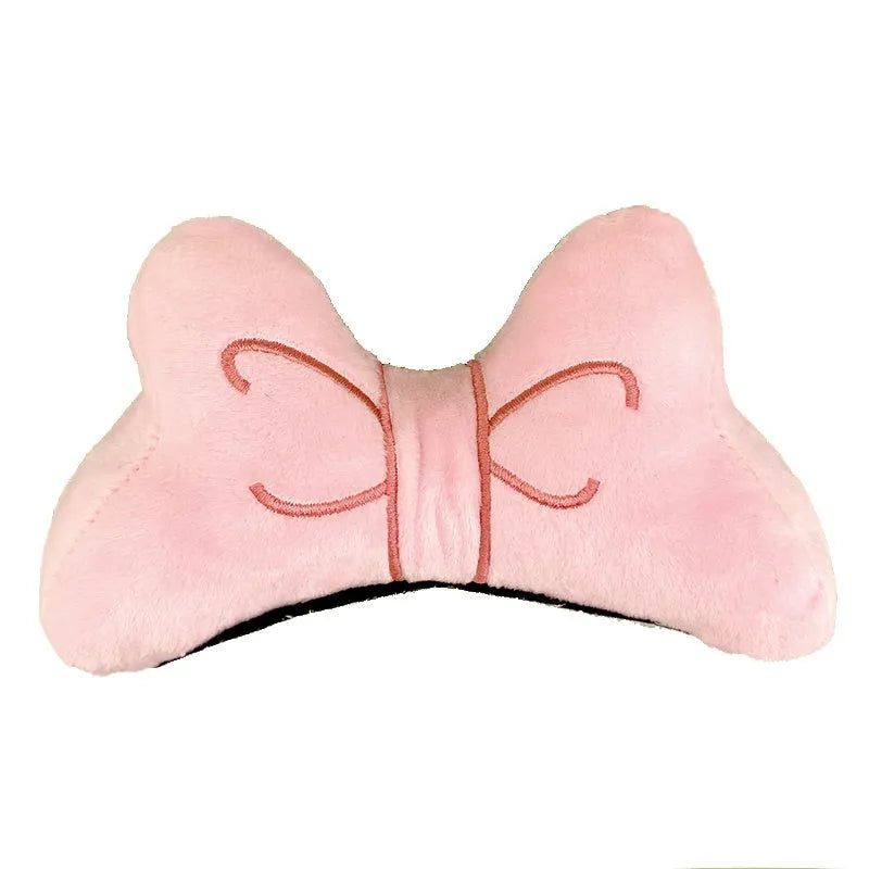 Soft plush bow tie decoration for helmets in red, peach pink, and rose pink on a motorcycle helmet.