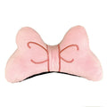 Soft plush bow tie decoration for helmets in red, peach pink, and rose pink on a motorcycle helmet.