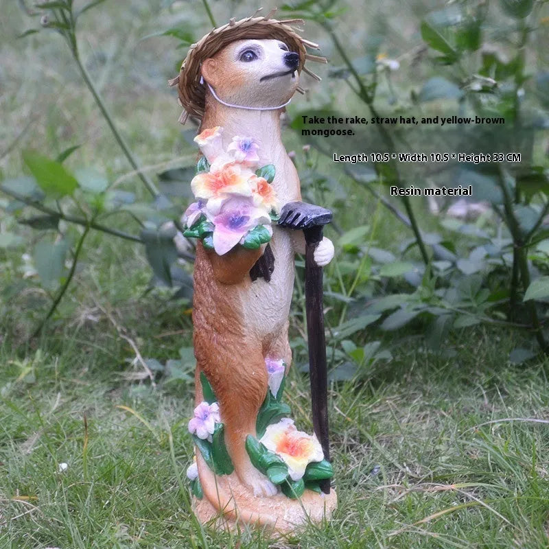 Three straw hat mongoose garden ornaments including mother and child grouping plus figures with rake and shovel