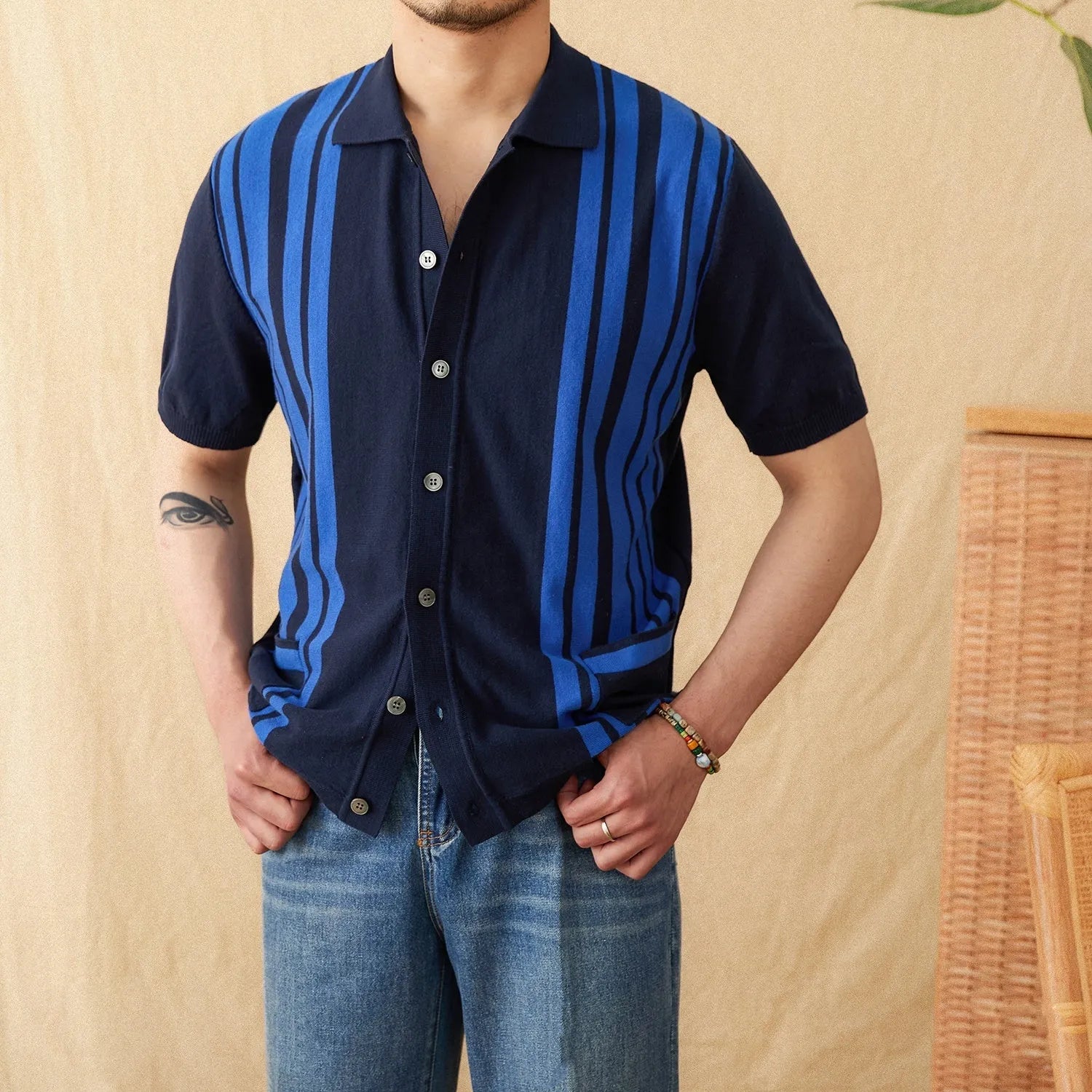 Light blue striped cotton polo cardigan with short sleeves and a lapel collar on a hanger.