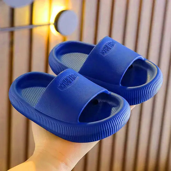Children's mixed colour EVA slippers with textured sole, shown in blue, green, orange, pink, and yellow.