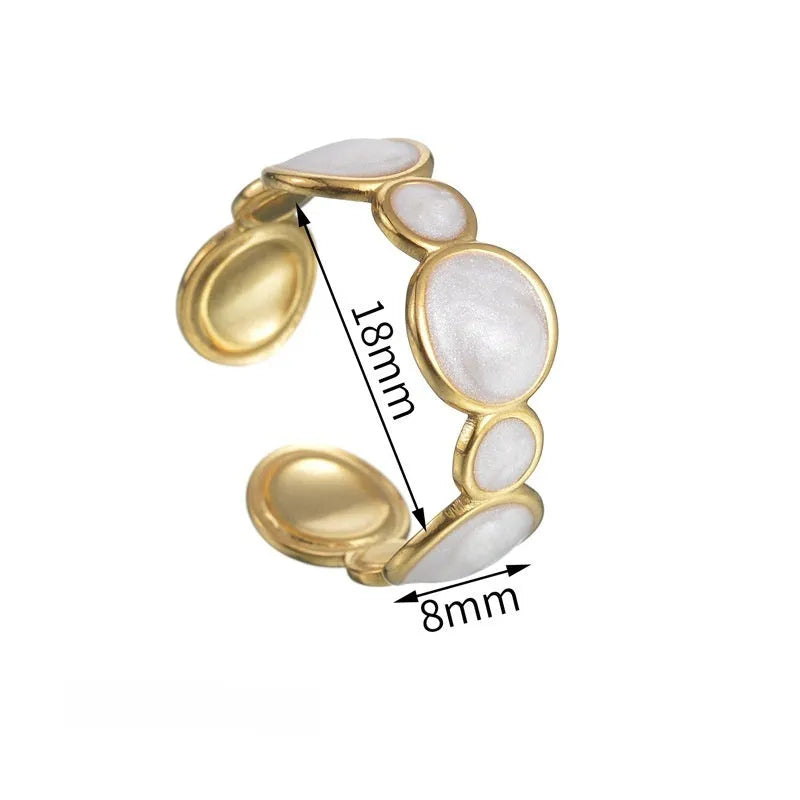 Geometric stainless steel ring with adjustable opening on a plain background.