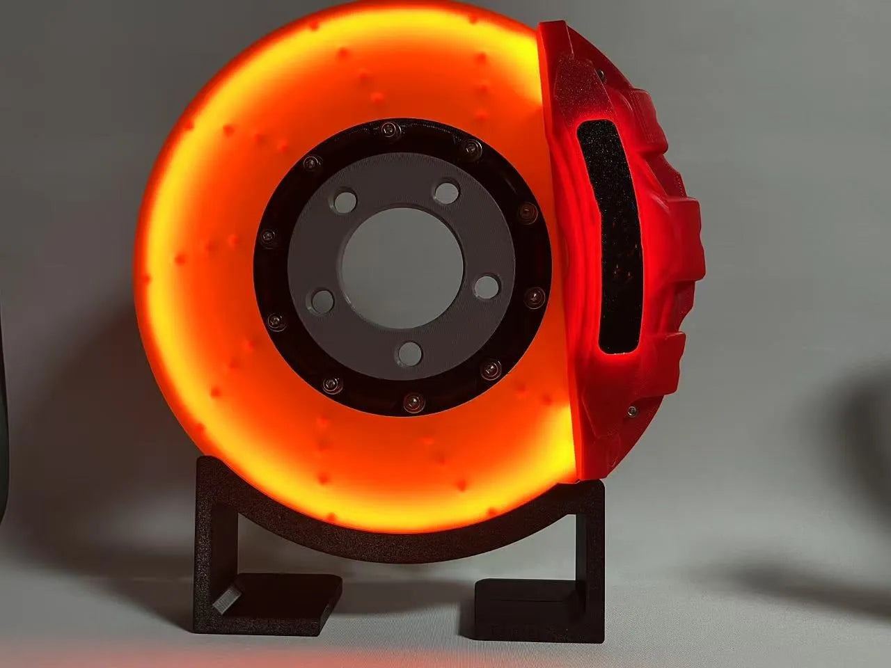 Brake disc design rechargeable LED night light with touch control in blue, red or yellow.