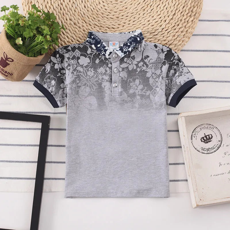 A solid colour short sleeve polo shirt for a young boy, made from soft cotton fabric.