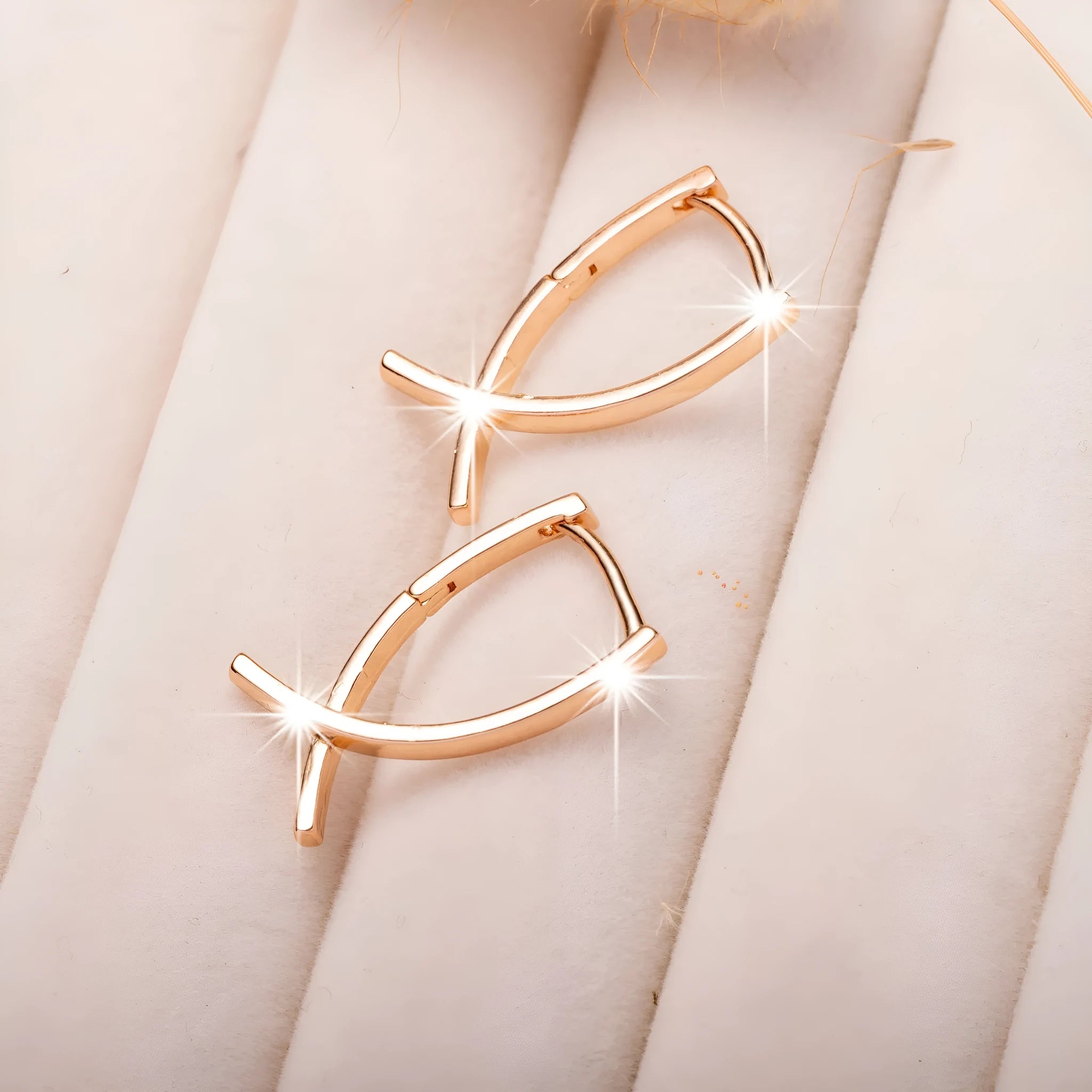 Rose gold plated cross-shaped earrings showing front design with post fitting.