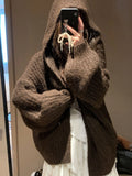 A woman's brown retro-style hooded cardigan with a loose fit, made from thick acrylic-polyester fabric.