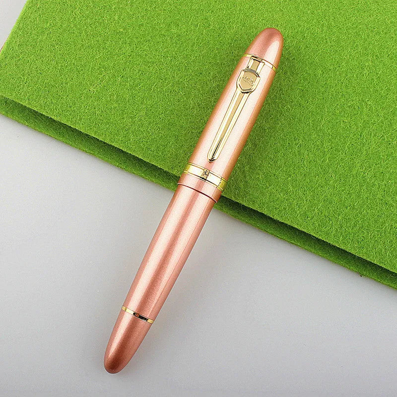 Metal ball pen with pearl beads, black body and silver clip, lying on a desk