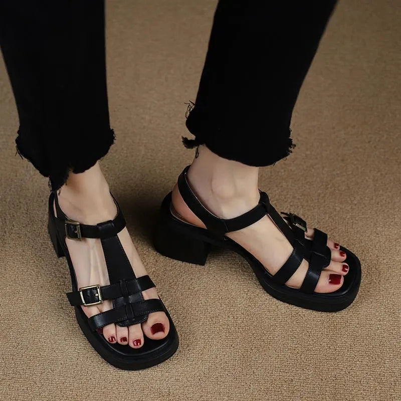 Black women's retro sandals with a T-buckle strap, chunky platform heel, and open square toe