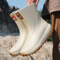 Men's PVC oversleeve rain boots in beige with a non-slip plastic sole.