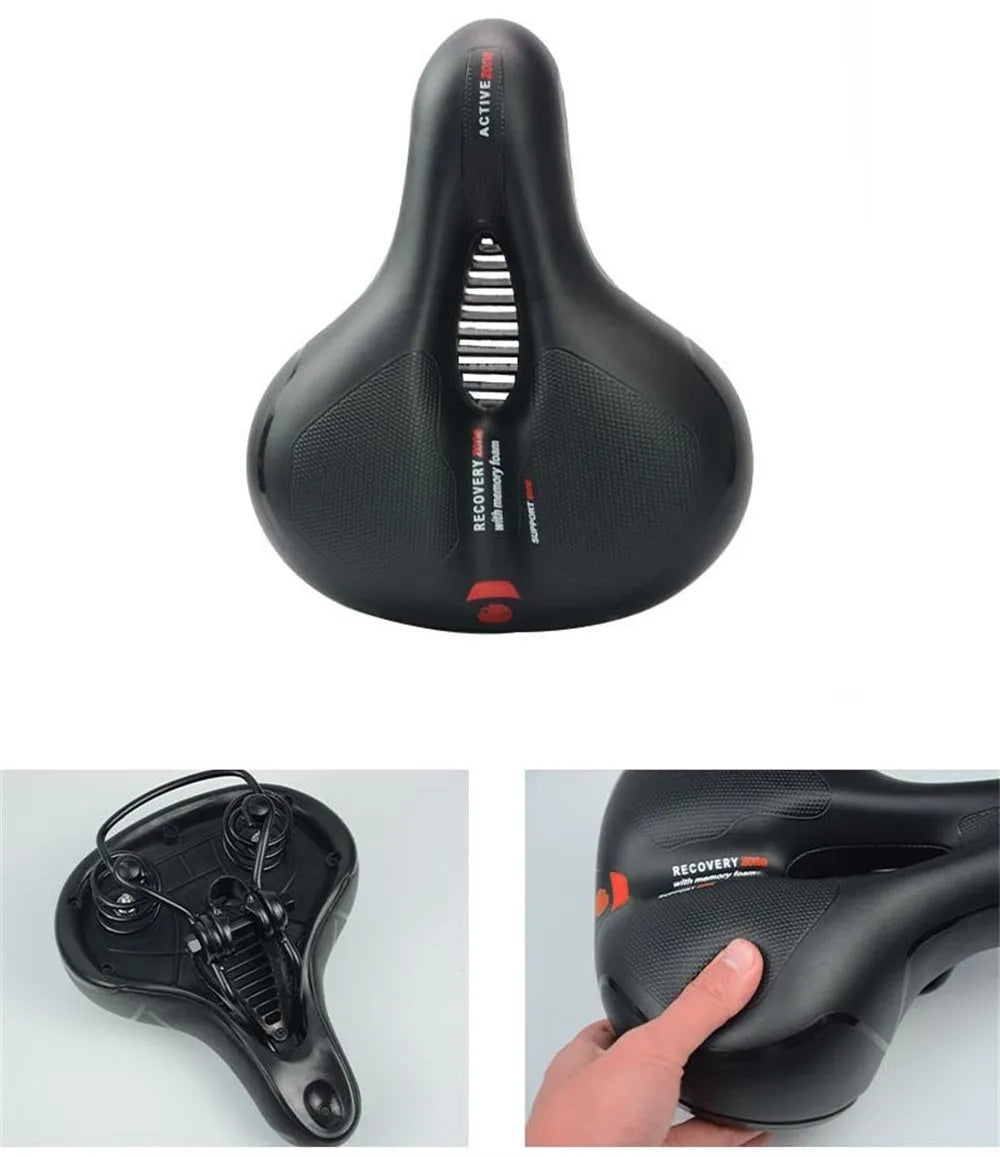 Black bicycle saddle with silicone padding and two visible steel springs underneath, shown with a waterproof cover and tools.