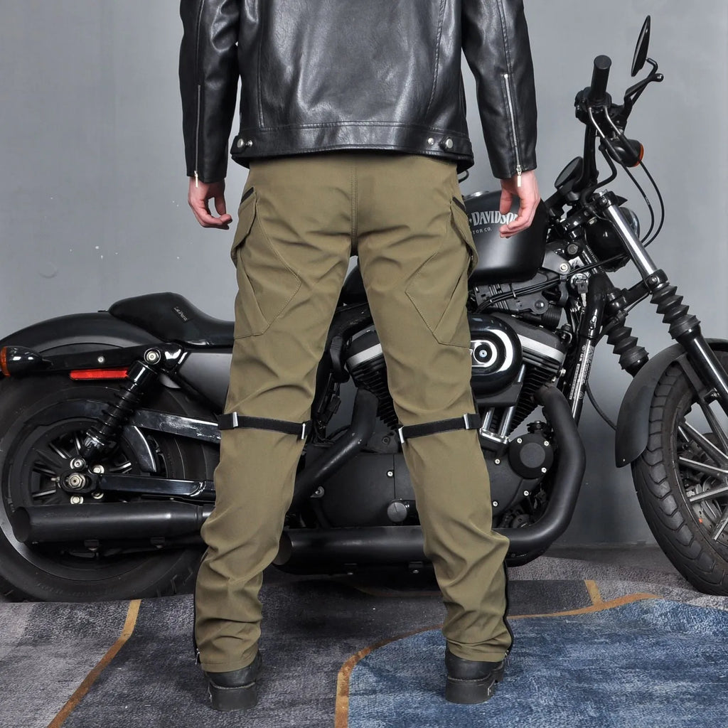 Men's green waterproof motorcycle trousers with belt and protective knee pads laid flat.