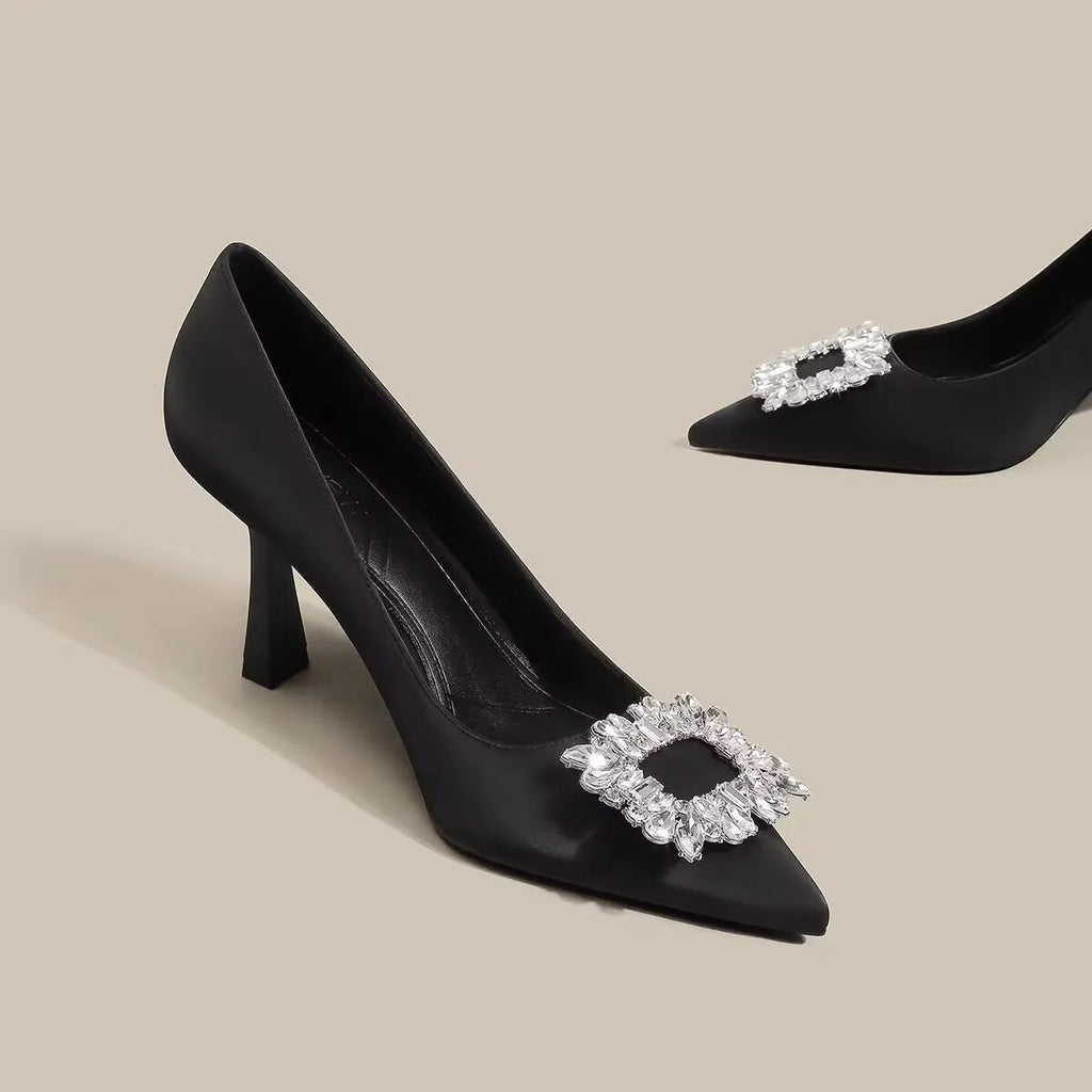 Women's pointed toe stiletto pumps in microfiber with a mid heel and rubber sole.