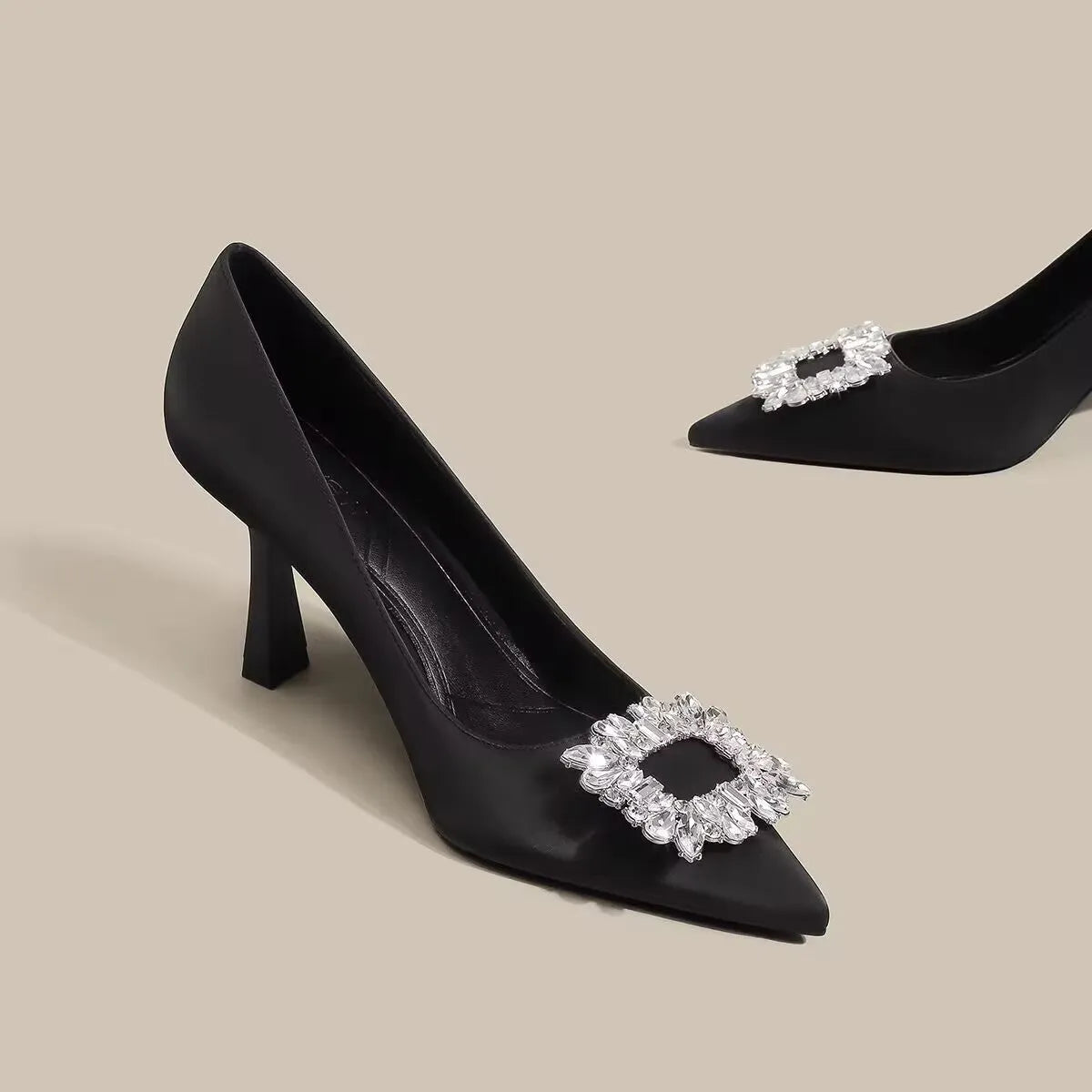 Women's pointed toe stiletto pumps in microfiber with a mid heel and rubber sole.
