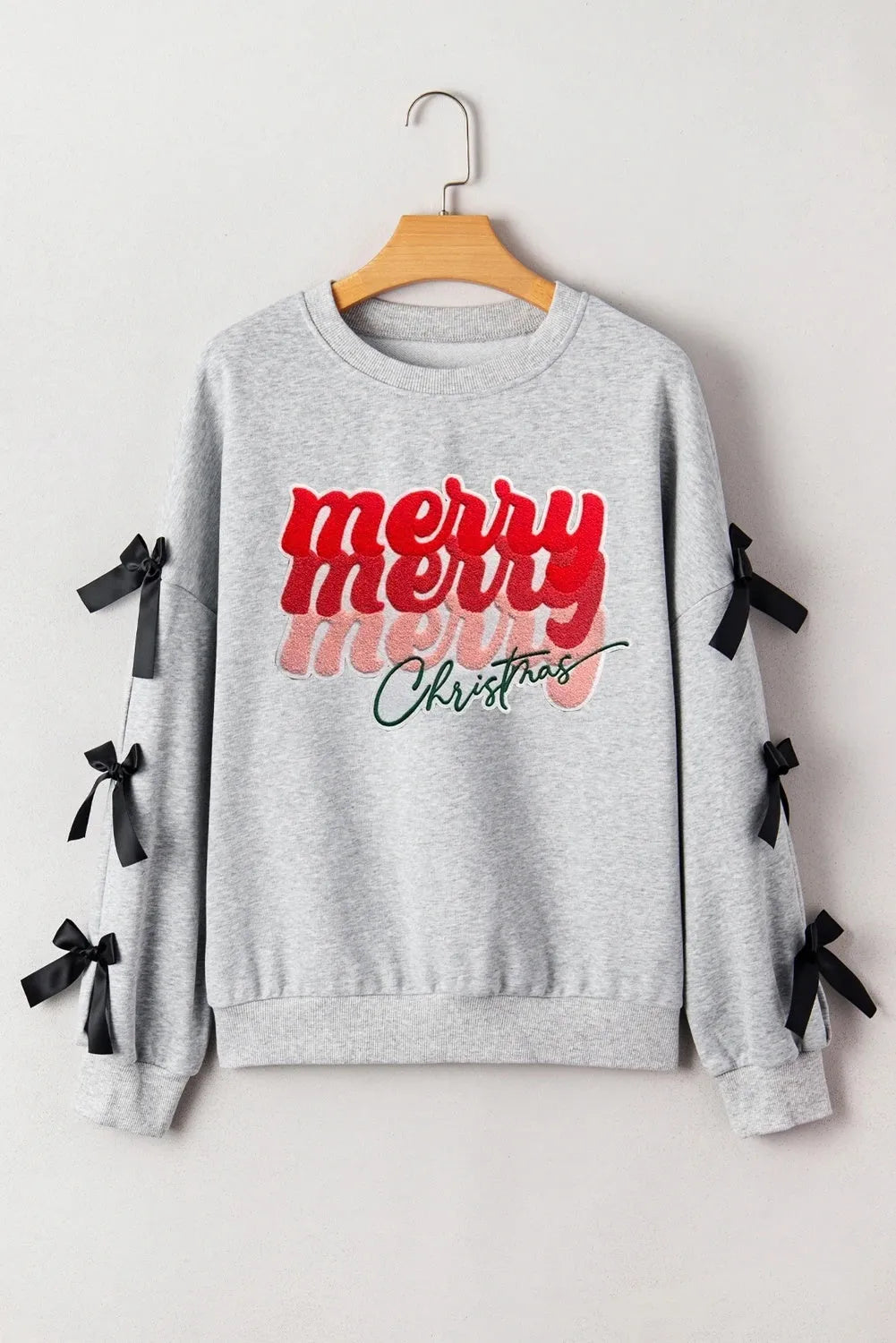 Women's light gray long sleeve ribbon slit letter shirt pullover front view on model