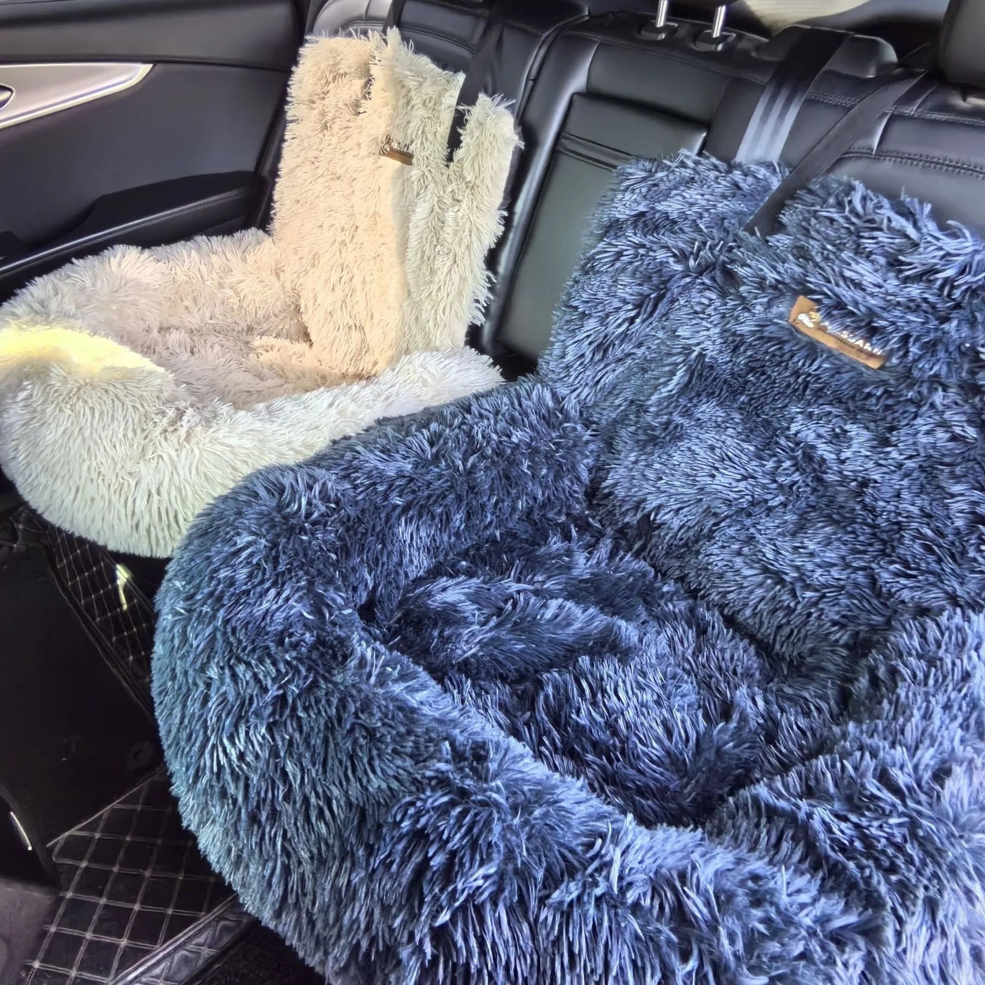 Beige fleece-lined pet mat with high sides placed on a grey car seat, showing its 50cm height and contained design.