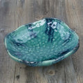 Japanese-style irregular coarse pottery sashimi bowl with floral decoration on glaze