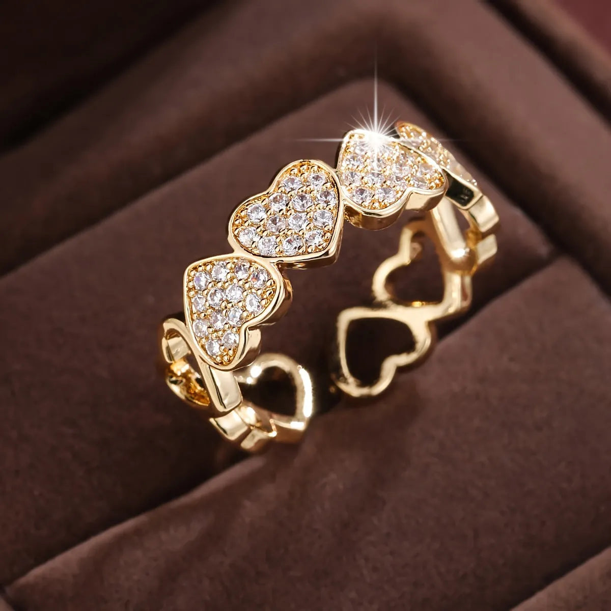 Geometric adjustable opening ring with a love heart detail in a choice of gold or silver tone finish.