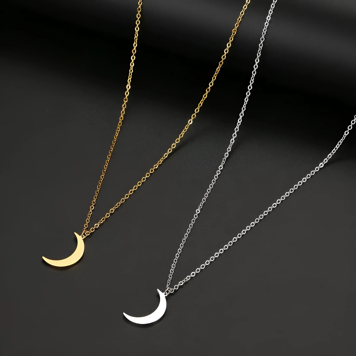 Women's stainless steel moon pendant necklace on a clavicle chain in gold or silver electroplated finish