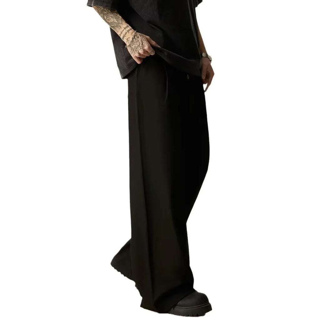 Men's solid colour cotton blend wide-leg casual trousers on a hanger, showing the straight-leg cut and button fly.