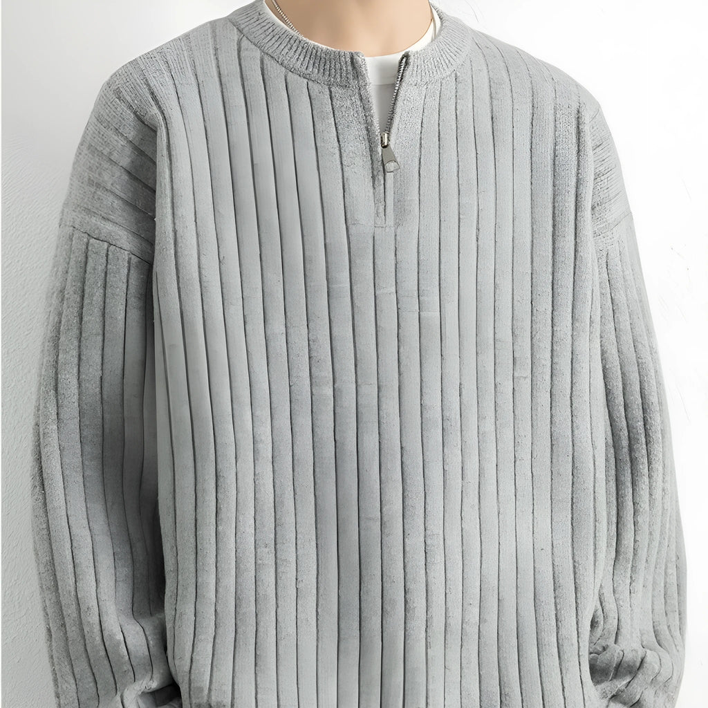 Men's loose grey half zip sweater with textured knit and long sleeves on a hanger.