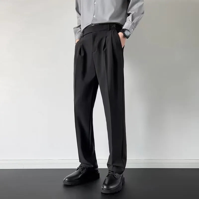 Men's straight leg loose fit suit trousers in apricot colour hanging on a hanger.