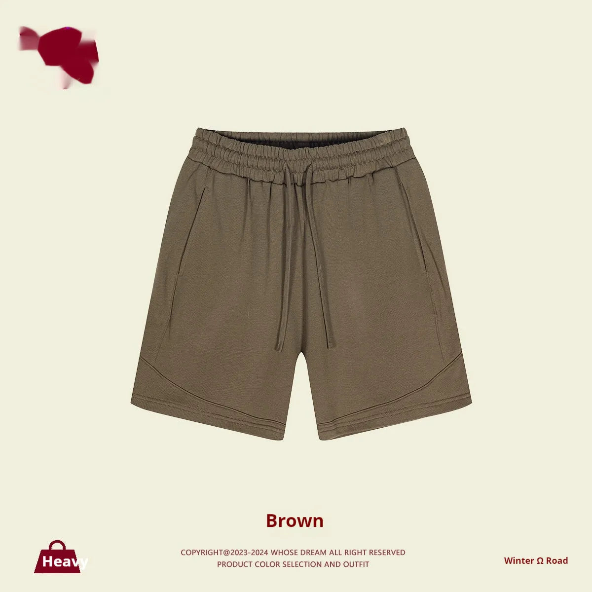 Child wearing solid colour loose cotton sports shorts in a neutral shade.