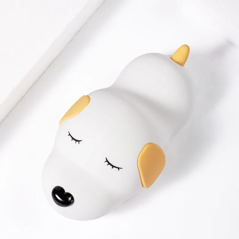 Cartoon dog design USB-charging silicone night lamp in two colours on a surface.