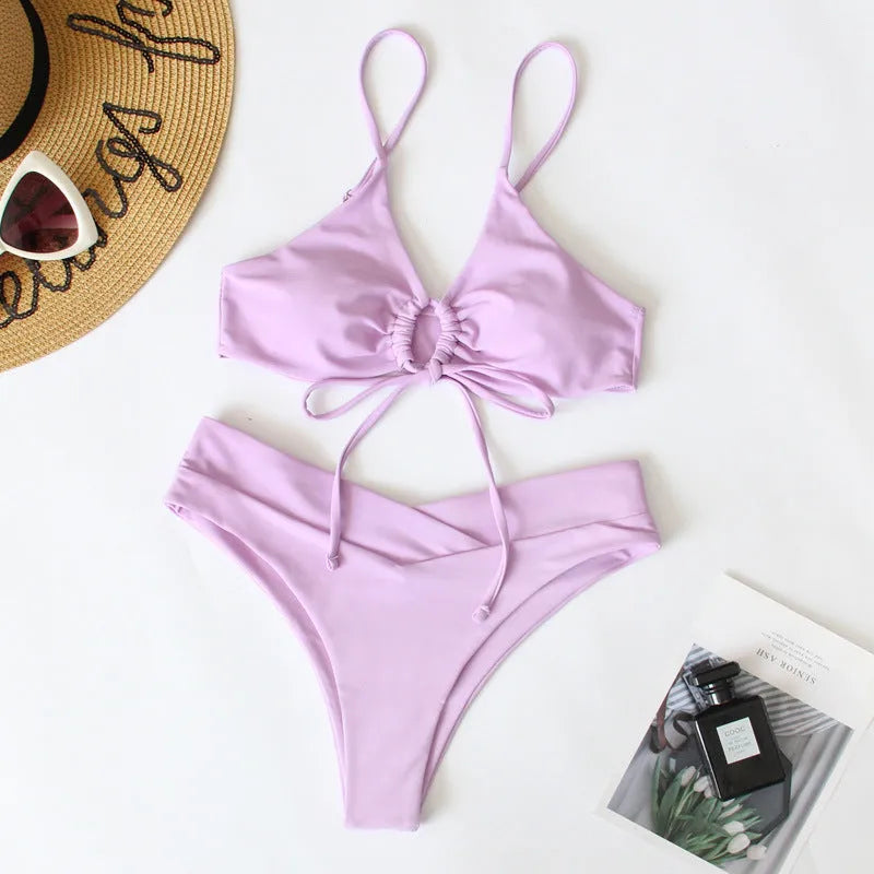 Women's pure colour tied bow split swimsuit bikini on a hanger, showing brief cut.