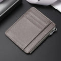 First layer cowhide leather card holder in solid colour with zipper closure on neutral background