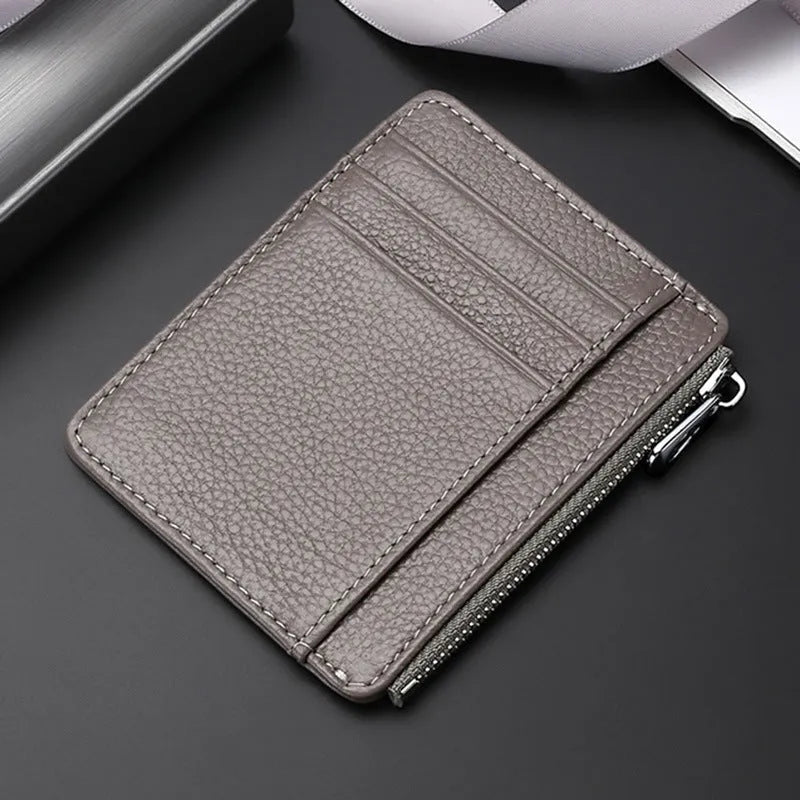 First layer cowhide leather card holder in solid colour with zipper closure on neutral background