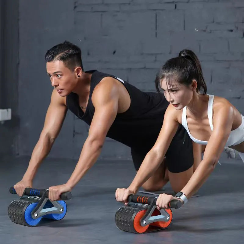 Double wheel abdominal exerciser with automatic rebound and blue kneeling pad on a dark surface