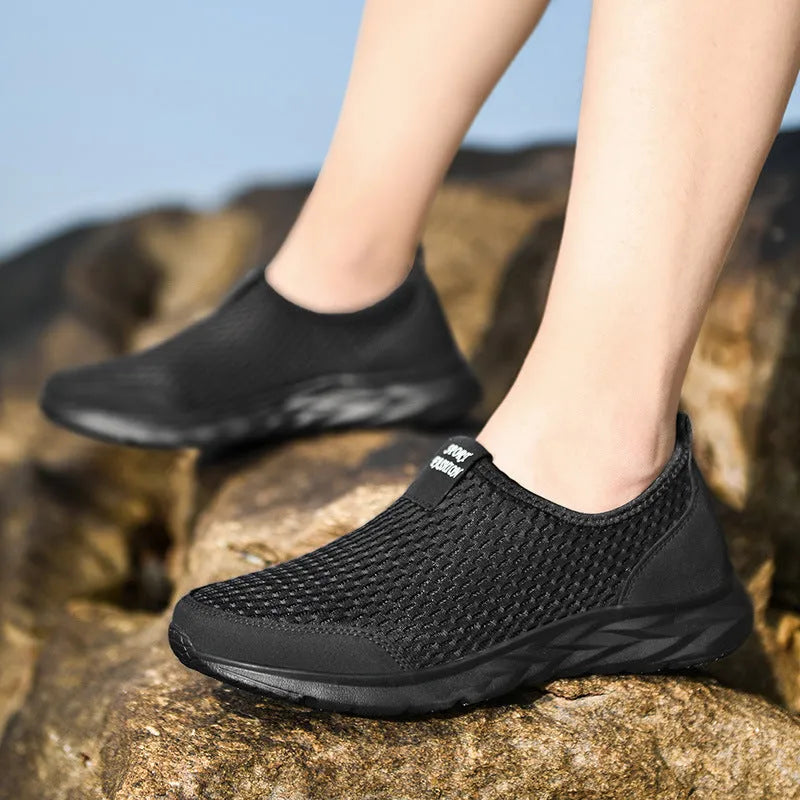 Pair of couple casual mesh shoes with PU mesh upper, hollow plaid detailing, and flat rubber sole in light gray, dark blue, black and white, or all black.
