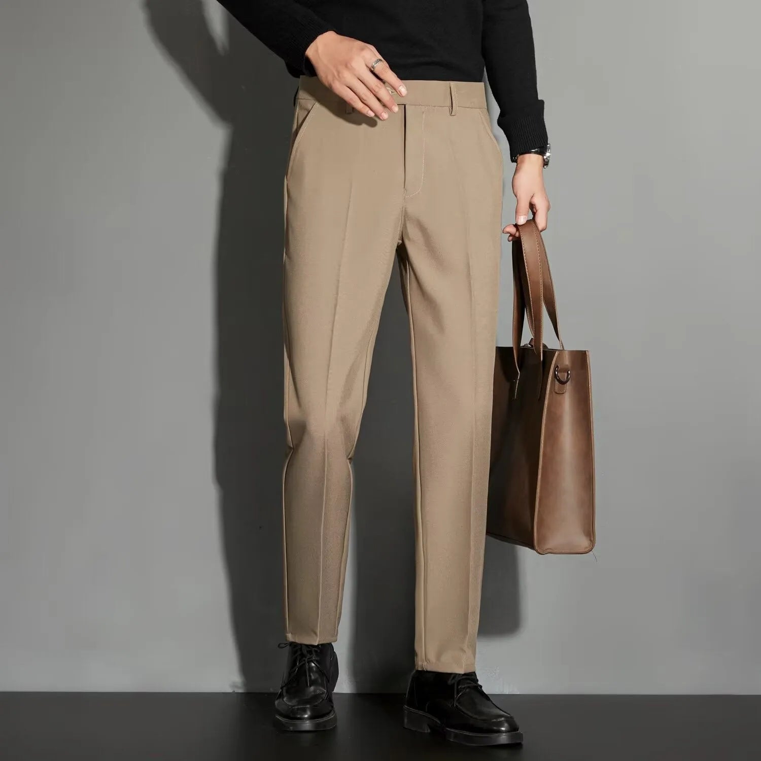 Men's straight-leg ankle-length suit trousers in a light colour, showing the spring draping effect on the leg.