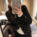 Women's grey dot pattern knitted cardigan with crocheted flower details on front