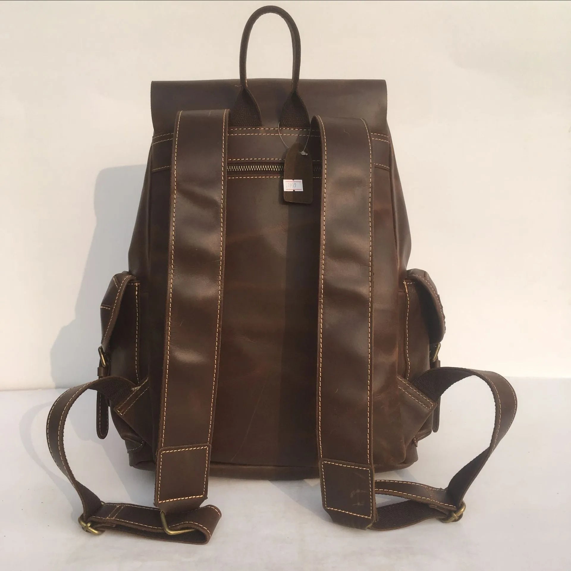 Brown men's cowhide leather backpack with air pillow shoulder straps and a single main compartment.
