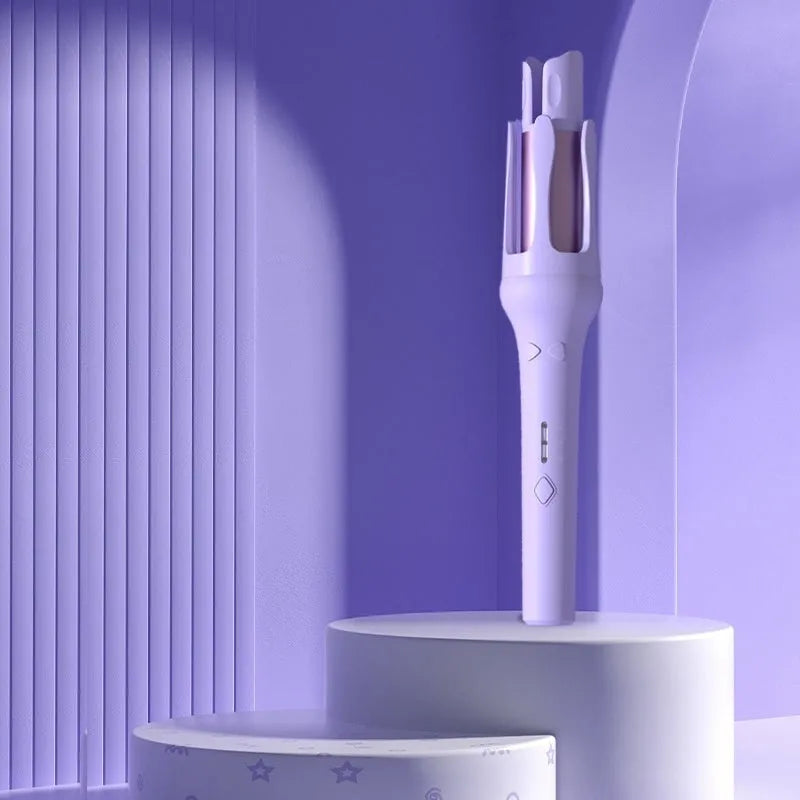 White and pink automatic hair curler with a 32mm rotating ceramic barrel and clamp, resting on a table with international power adapters.