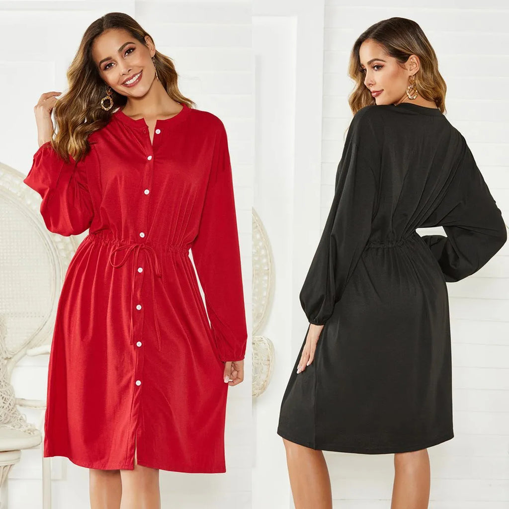 Black mid-length A-line dress with long sleeves, elasticated waist, and a detachable red belt.