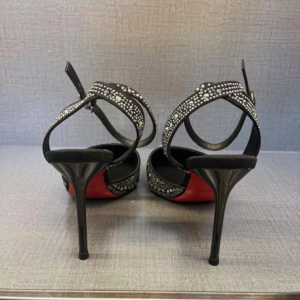 Women's black high heels with hollow red stiletto heel and pointed toe.