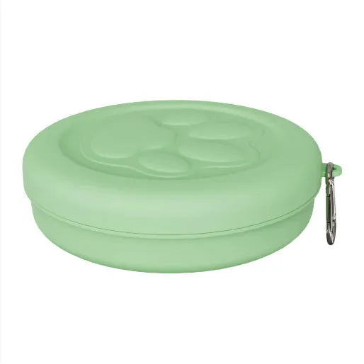 Collapsed and open views of a pink silicone dog bowl with matching sealing lid, next to a dog lead.