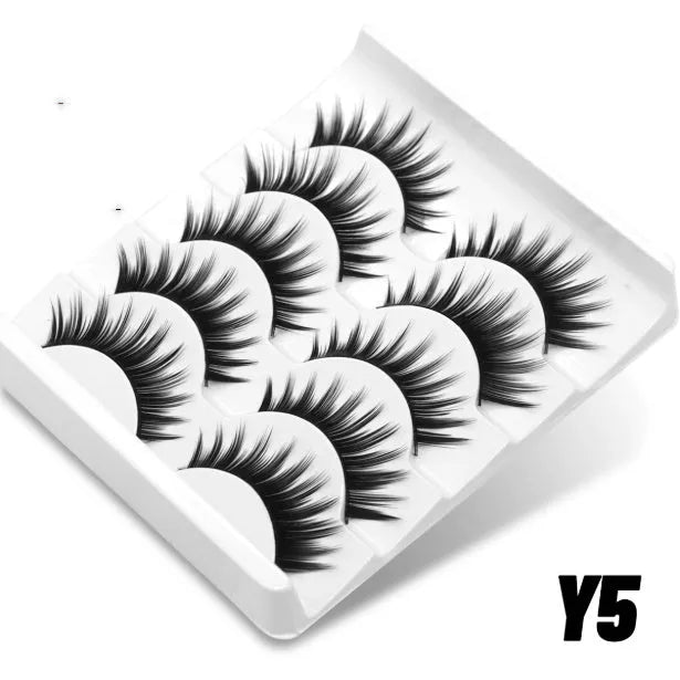 Box of black artificial fibre false eyelashes in a natural thick style with a tube of adhesive glue.