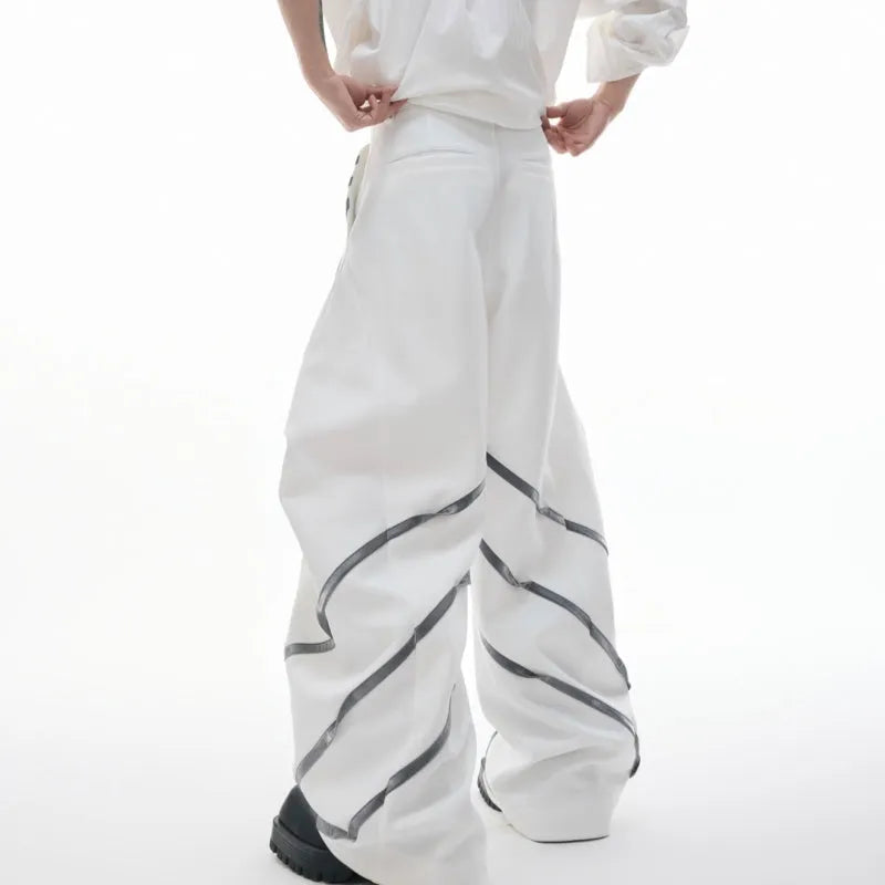 Men's black polyester trousers with three-dimensional cut and metal striped rivets on the pleats.