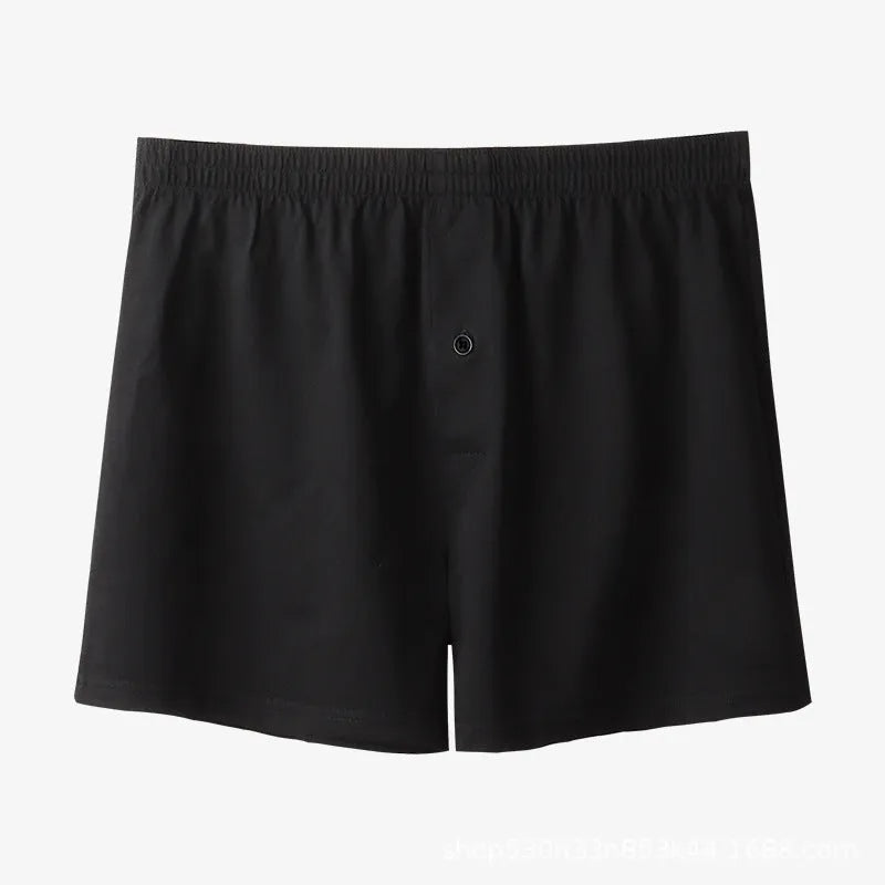Men's solid colour cotton boxer shorts on a hanger, showing loose fit and high waist.